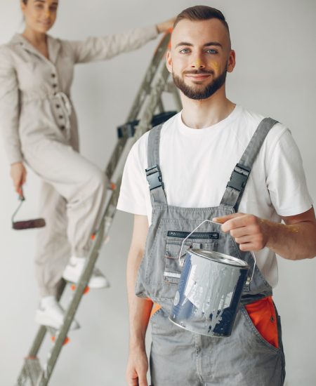 Family repairs. Couple at home. Woman in a overalls